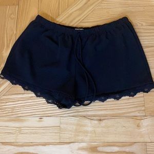 Black, lace trimmed shorts. Elastic waist band.